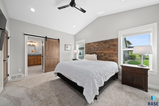 920 S Torrey Pine Ln, Sioux Falls, SD 57110 - bedroom with a barn door, lofted ceiling, light colored carpet, recessed lighting, and connected bathroom