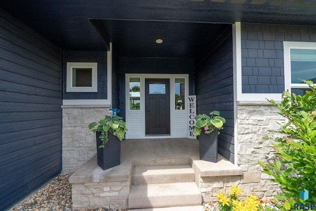 920 S Torrey Pine Ln, Sioux Falls, SD 57110 - entrance to property featuring covered porch and stone siding