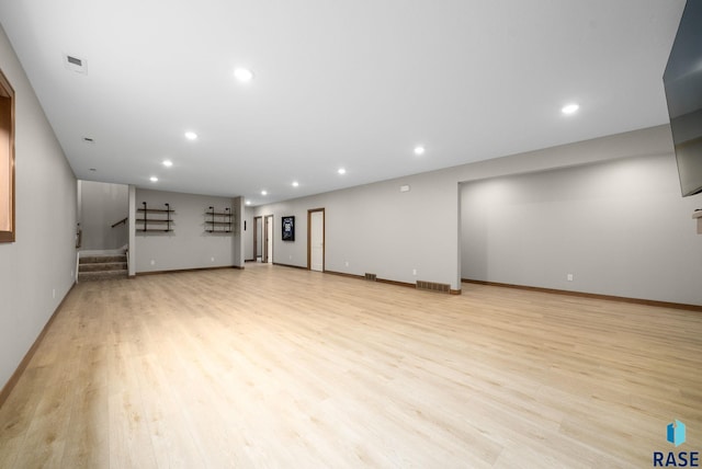 920 S Torrey Pine Ln, Sioux Falls, SD 57110 - unfurnished living room featuring light wood finished floors, stairs, and recessed lighting