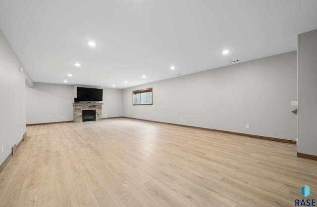 920 S Torrey Pine Ln, Sioux Falls, SD 57110 - unfurnished living room featuring recessed lighting, a fireplace, and light wood-style flooring