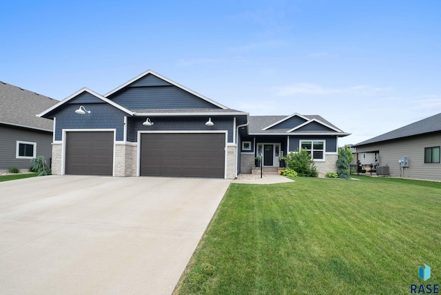 920 S Torrey Pine Ln, Sioux Falls, SD 57110 - craftsman-style home featuring a garage, a front yard, concrete driveway, and stone siding