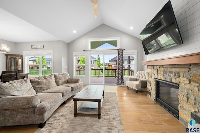 920 S Torrey Pine Ln, Sioux Falls, SD 57110 - living area featuring a stone fireplace, light wood finished floors, lofted ceiling, recessed lighting, and a chandelier