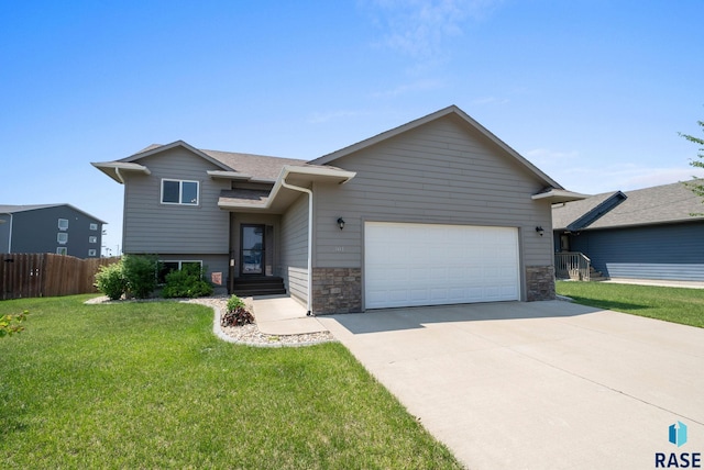 301 N Jenny Ave, Tea, SD 57064 - view of front of house featuring a garage, driveway, stone siding, and a shingled roof