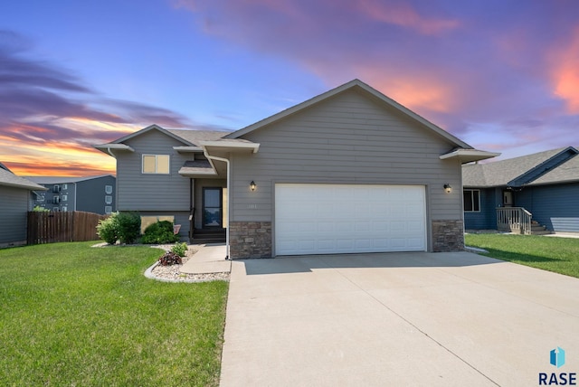 301 N Jenny Ave, Tea, SD 57064 - view of front facade with stone siding, an attached garage, and driveway