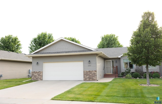 6707 S Witzke Ave, Sioux Falls, SD 57108 - single story home with brick siding, an attached garage, driveway, and a front lawn