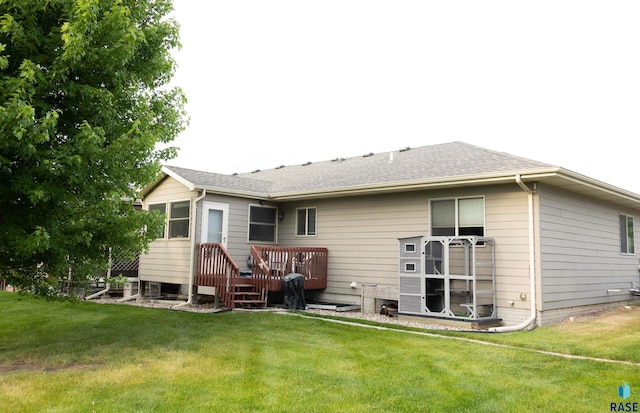 6707 S Witzke Ave, Sioux Falls, SD 57108 - rear view of house with a lawn and a wooden deck
