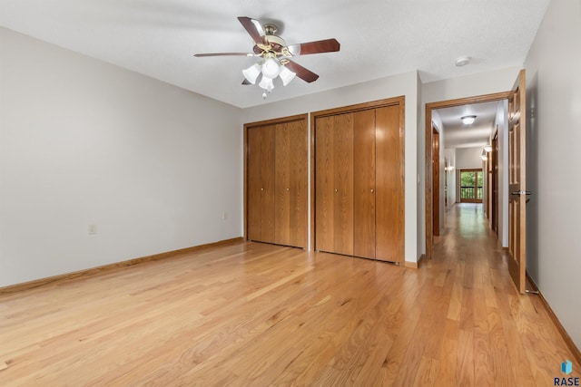 4220 S Minnesota Ave Unit 206, Sioux Falls, SD 57105 - unfurnished bedroom featuring two closets, light wood-type flooring, and ceiling fan