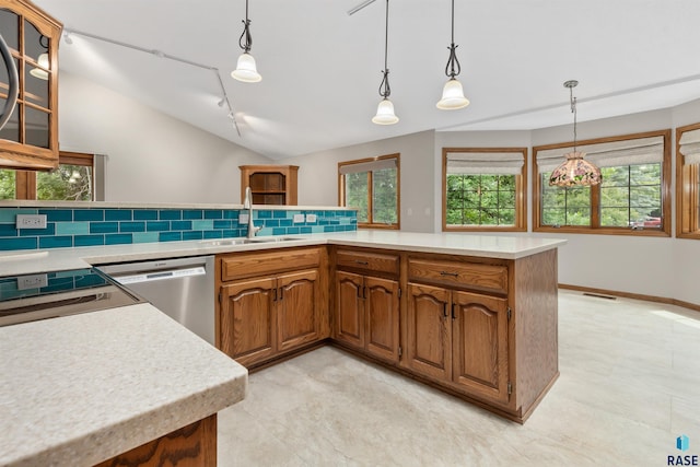 4220 S Minnesota Ave Unit 206, Sioux Falls, SD 57105 - kitchen with dishwasher, decorative backsplash, vaulted ceiling, light countertops, and brown cabinetry
