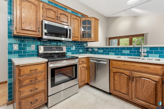 4220 S Minnesota Ave Unit 206, Sioux Falls, SD 57105 - kitchen featuring stainless steel appliances, track lighting, brown cabinets, and light countertops