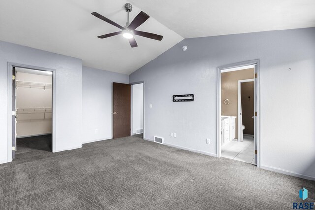 6304 S Audie Dr, Sioux Falls, SD 57108 - unfurnished bedroom with vaulted ceiling, a spacious closet, carpet, a closet, and ensuite bathroom