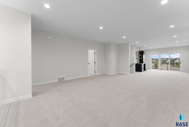 104 N Bryggen Pl, Sioux Falls, SD 57107 - unfurnished living room featuring light colored carpet and recessed lighting