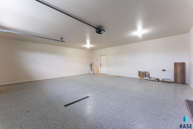 104 N Bryggen Pl, Sioux Falls, SD 57107 - garage featuring baseboards and a garage door opener
