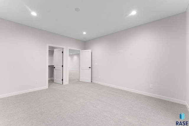 104 N Bryggen Pl, Sioux Falls, SD 57107 - unfurnished bedroom with light colored carpet, recessed lighting, and a walk in closet