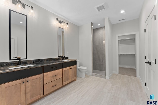 104 N Bryggen Pl, Sioux Falls, SD 57107 - bathroom featuring double vanity, a tile shower, a spacious closet, and recessed lighting