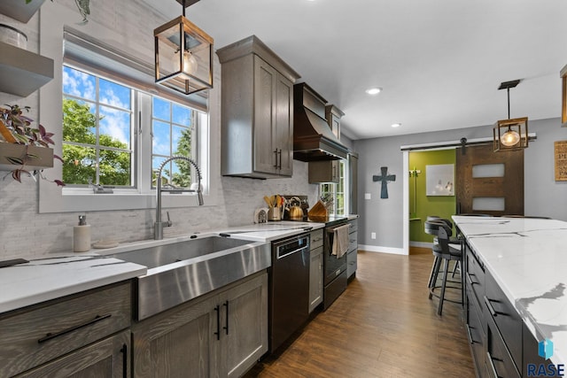 4513 S Southridge Dr, Sioux Falls, SD 57105 - kitchen with dishwashing machine, wall chimney range hood, decorative backsplash, a barn door, and recessed lighting