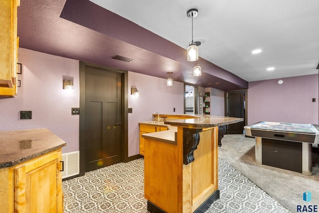 4513 S Southridge Dr, Sioux Falls, SD 57105 - kitchen featuring a textured wall, a breakfast bar, hanging light fixtures, light carpet, and recessed lighting