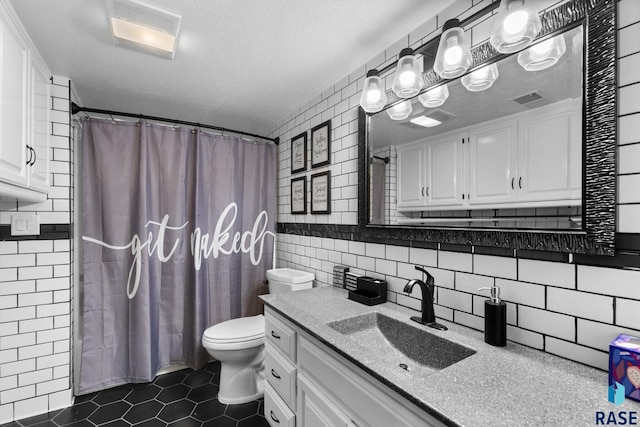 4513 S Southridge Dr, Sioux Falls, SD 57105 - bathroom with tile walls, tile patterned flooring, vanity, curtained shower, and a textured ceiling