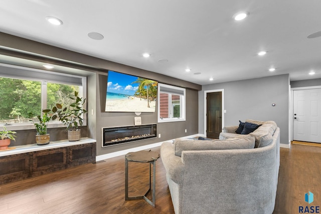 4513 S Southridge Dr, Sioux Falls, SD 57105 - living room with recessed lighting, a glass covered fireplace, healthy amount of natural light, and wood finished floors