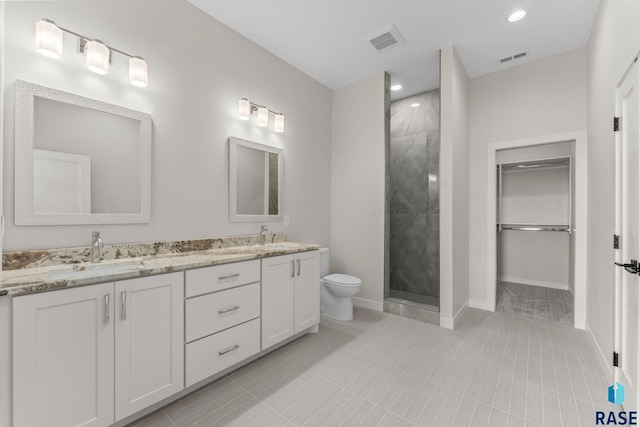 106 N Bryggen Pl, Sioux Falls, SD 57107 - bathroom featuring double vanity, a stall shower, a spacious closet, tile patterned flooring, and recessed lighting