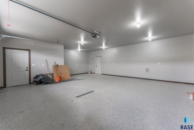 8619 W Shoreline Pl, Sioux Falls, SD 57107 - garage featuring a garage door opener and baseboards