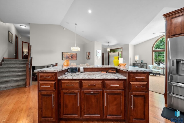 4400 E Aster Cir, Sioux Falls, SD 57103 - kitchen featuring stainless steel refrigerator with ice dispenser, vaulted ceiling, light wood-type flooring, light stone countertops, and a center island