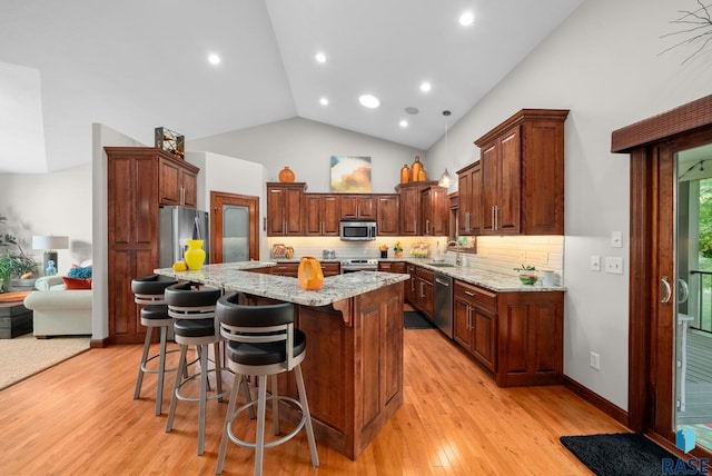 4400 E Aster Cir, Sioux Falls, SD 57103 - kitchen with appliances with stainless steel finishes, tasteful backsplash, light stone countertops, high vaulted ceiling, and recessed lighting
