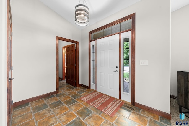 4400 E Aster Cir, Sioux Falls, SD 57103 - entryway featuring dark stone finish floors and vaulted ceiling