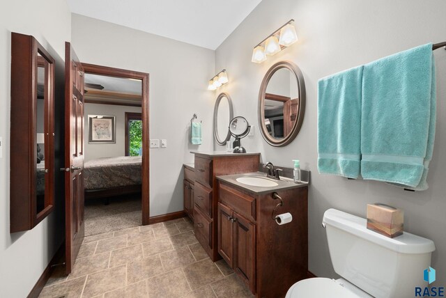 4400 E Aster Cir, Sioux Falls, SD 57103 - ensuite bathroom featuring vanity and stone finish floors