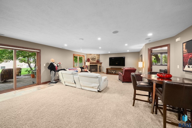 4400 E Aster Cir, Sioux Falls, SD 57103 - living area with recessed lighting, plenty of natural light, a stone fireplace, and light carpet