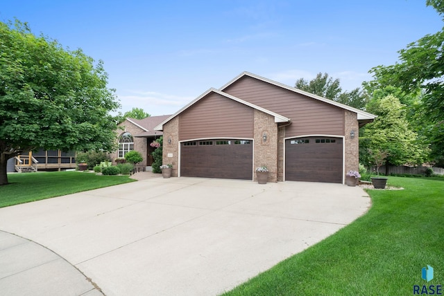 4400 E Aster Cir, Sioux Falls, SD 57103 - view of front facade with a garage, brick siding, concrete driveway, and a front lawn