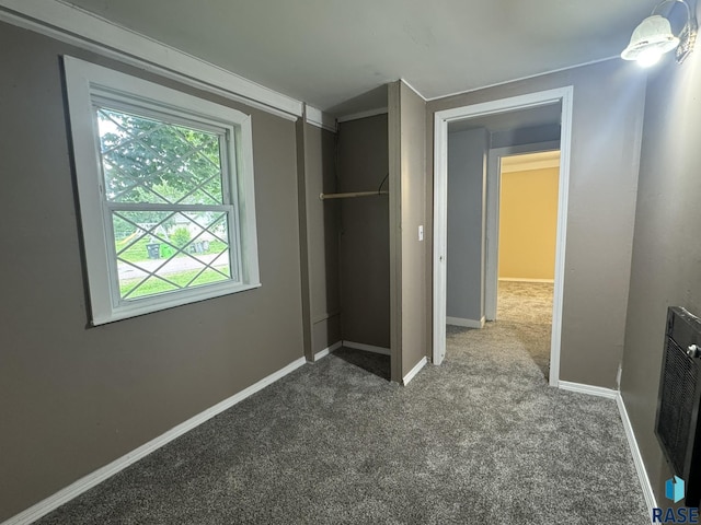 651 N 5th Ave, Canistota, SD 57012 - unfurnished bedroom featuring carpet floors, multiple windows, a closet, and heating unit