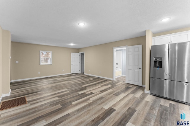 307 W Oak St, Beresford, SD 57004 - unfurnished living room featuring light wood-style floors, a textured ceiling, and recessed lighting