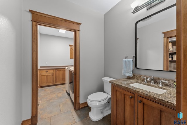 9005 E Torrey Pine Cir, Sioux Falls, SD 57110 - half bathroom with vanity, separate washer and dryer, and stone finish flooring