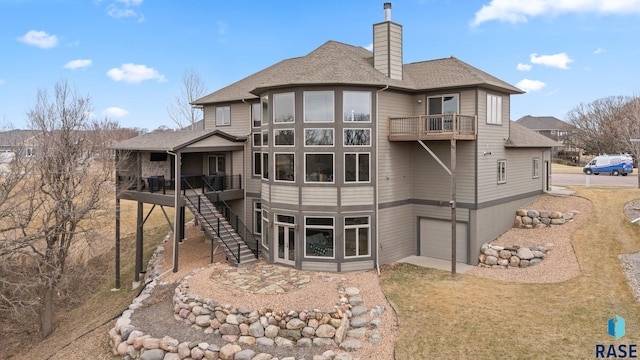 9005 E Torrey Pine Cir, Sioux Falls, SD 57110 - rear view of property with a balcony, a chimney, a shingled roof, and stairs