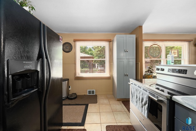 26045 485th Ave, Valley Springs, SD 57068 - kitchen featuring black fridge, electric stove, light tile patterned floors, and gray cabinetry