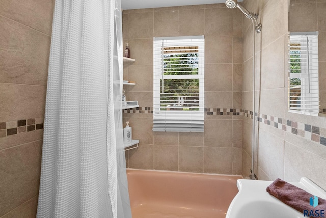 26045 485th Ave, Valley Springs, SD 57068 - bathroom featuring shower / tub combo and tile walls