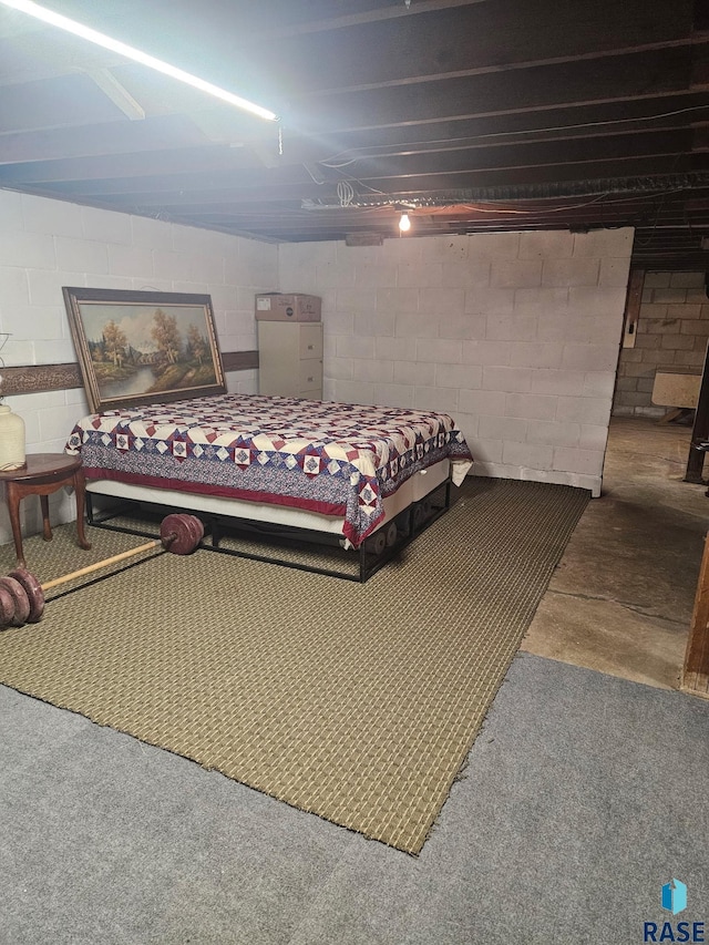 26045 485th Ave, Valley Springs, SD 57068 - bedroom featuring concrete block wall and a ceiling fan