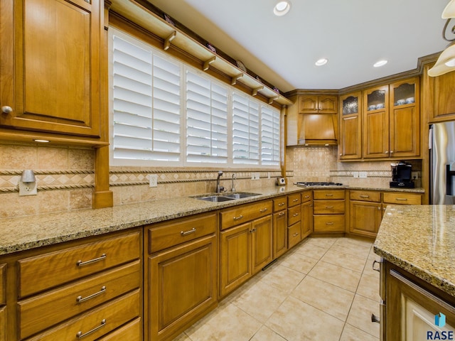 18 S Elkjer Cir, Sioux Falls, SD 57103 - kitchen with custom range hood, stainless steel appliances, brown cabinets, decorative backsplash, and recessed lighting