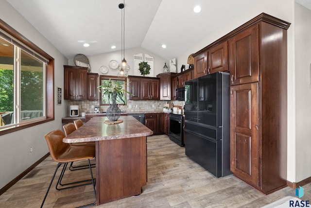 212 N Fairway Dr, Brandon, SD 57005 - kitchen with black appliances, vaulted ceiling, a center island, decorative backsplash, and light wood-style flooring