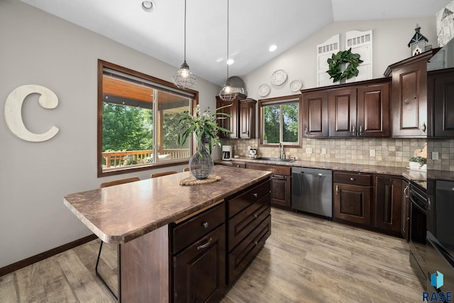 212 N Fairway Dr, Brandon, SD 57005 - kitchen featuring stainless steel dishwasher, decorative backsplash, a center island, vaulted ceiling, and light wood-type flooring