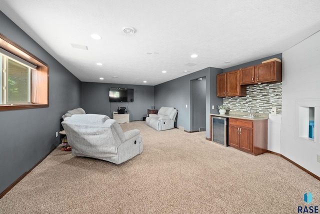 212 N Fairway Dr, Brandon, SD 57005 - living room with beverage cooler, light carpet, and recessed lighting