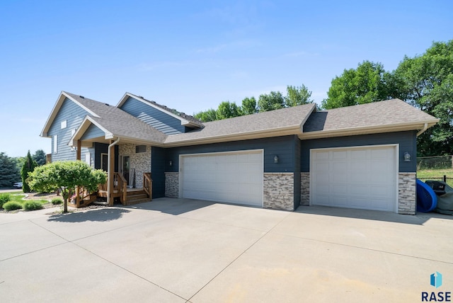 212 N Fairway Dr, Brandon, SD 57005 - ranch-style home with a garage, driveway, stone siding, and a shingled roof