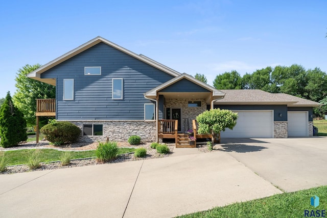 212 N Fairway Dr, Brandon, SD 57005 - view of front facade with a garage, stone siding, and driveway