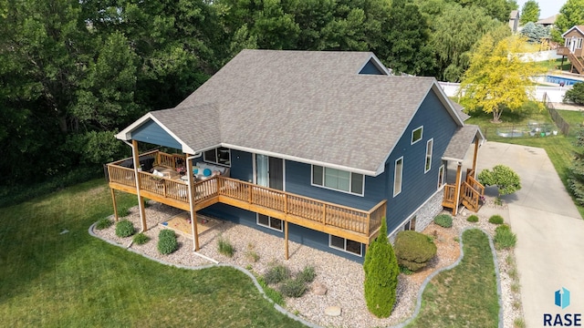212 N Fairway Dr, Brandon, SD 57005 - rear view of house featuring roof with shingles, a wooden deck, and a lawn