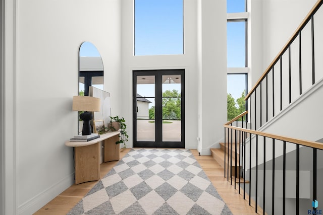 1617 S Scarlet Oak Pl, Sioux Falls, SD 57110 - foyer featuring a towering ceiling, light wood-style flooring, and stairway