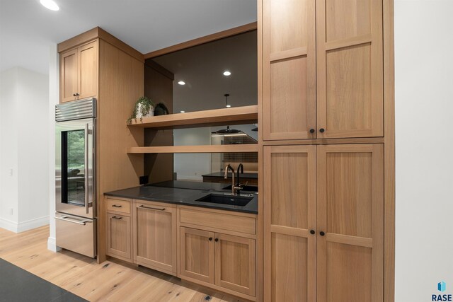 1617 S Scarlet Oak Pl, Sioux Falls, SD 57110 - kitchen with stainless steel built in refrigerator, dark countertops, light wood-style floors, open shelves, and recessed lighting