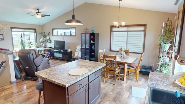 210 Lindsay Dr, Aurora, SD 57002 - kitchen with light wood-style flooring, open floor plan, lofted ceiling, ceiling fan, and hanging light fixtures