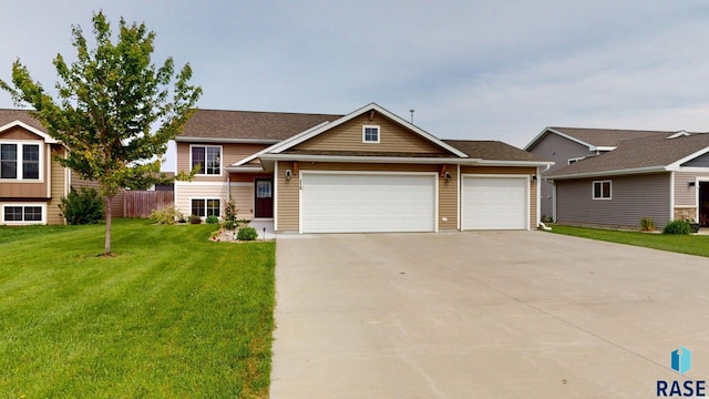 210 Lindsay Dr, Aurora, SD 57002 - view of front of house featuring a front lawn, an attached garage, and concrete driveway