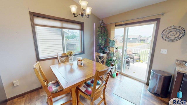 210 Lindsay Dr, Aurora, SD 57002 - dining area featuring light wood-style floors and a chandelier