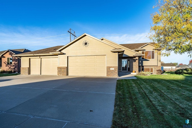 3121 S Dubuque Ave, Sioux Falls, SD 57110 - view of front facade featuring brick siding, concrete driveway, a garage, and a front lawn